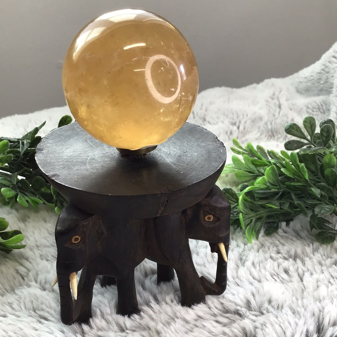 Elephant sphere holder with bone tusks